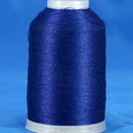 Navy blue thread wound on white plastic cone against blue background