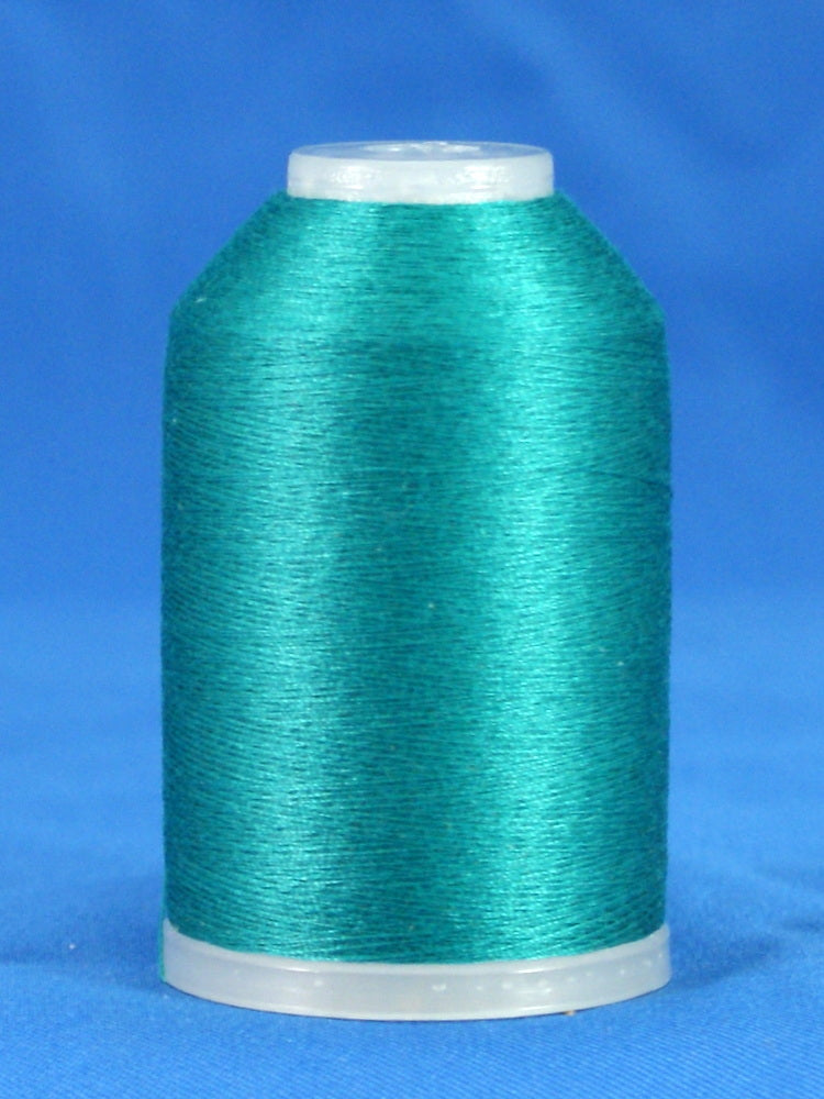 Kent green thread cone on white plastic spool against blue background, showing smooth wound thread surface