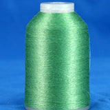 Green thread cone with white plastic cap and base against blue background
