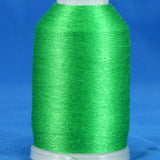 Kelly green thread wound on white plastic cone spool against blue background