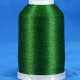 Hunter green embroidery thread wound on white plastic cone against blue background