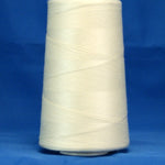Natural colored thread wound on white cone spool against blue background