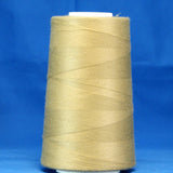 Khaki colored thread wound on white cone spool against blue background