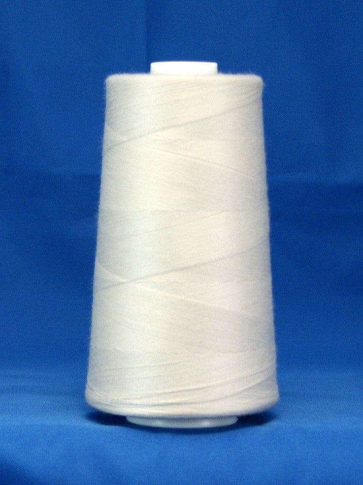 White thread wound on large cone spool against blue background