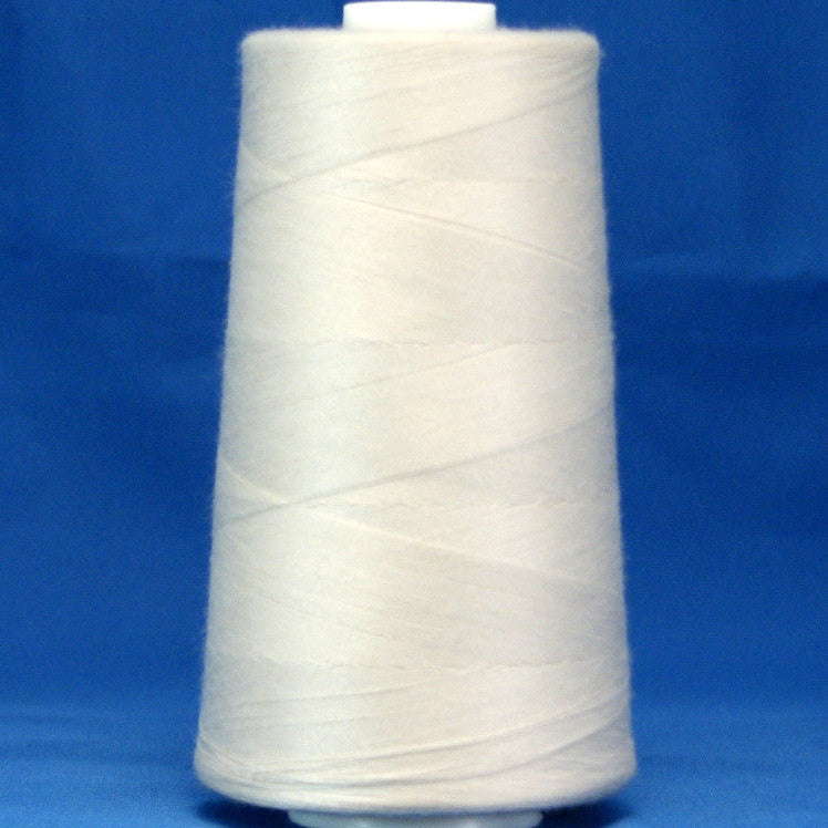 White thread wound on large cone spool against blue background