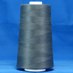 Storm grey thread wound on white plastic cone against bright blue background