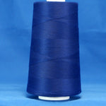 Royal blue thread wound on white plastic cone against blue background