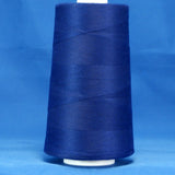Royal blue thread wound on white plastic cone against blue background