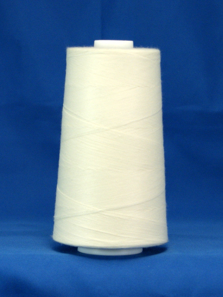 White thread wound on large conical spool against blue background