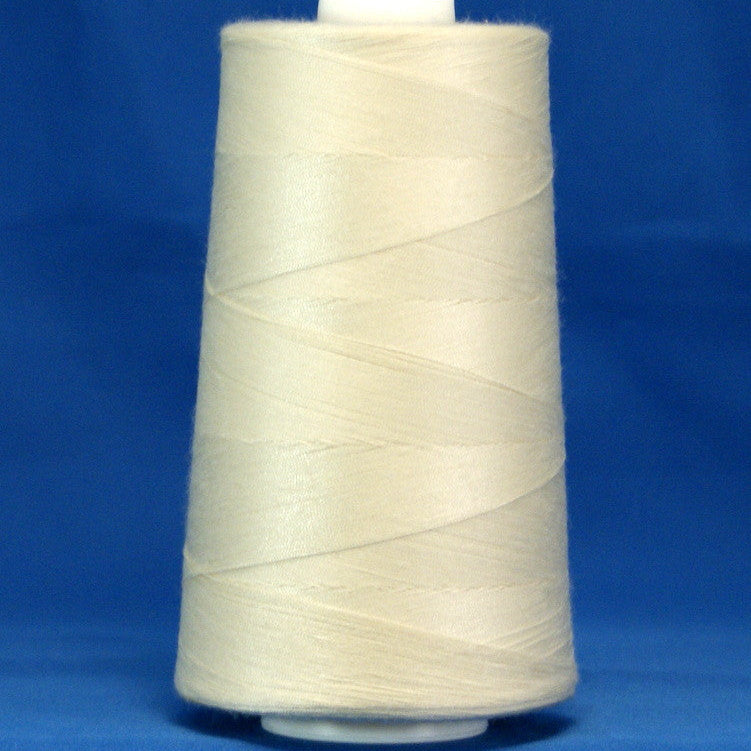 Off white thread wound on large industrial cone spool against blue background