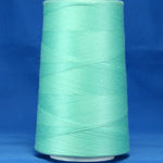 Aqua green thread wound on white plastic cone against blue background