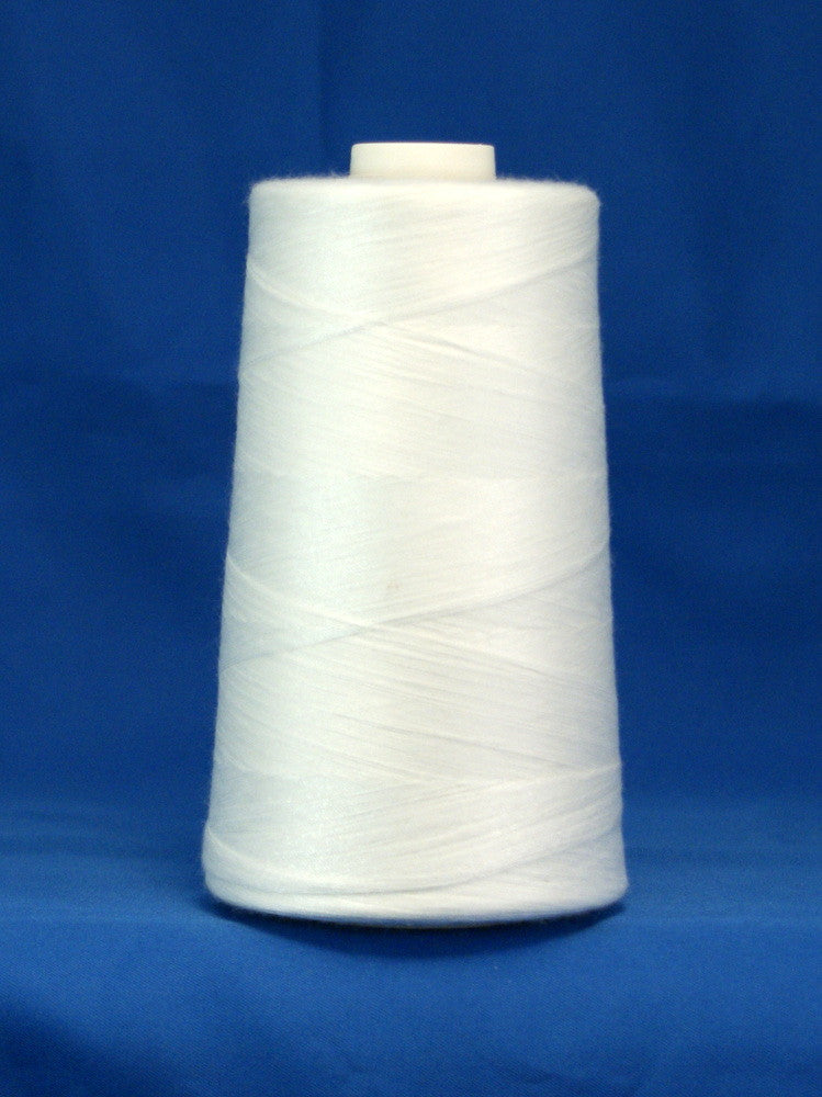 White thread wound on conical spool against blue background