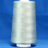 Light gray thread cone on white plastic spool against blue background, showing smooth wound thread texture