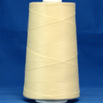 Cream colored thread wound on white plastic cone against blue background