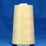 Parchment colored thread wound on white plastic cone against blue background