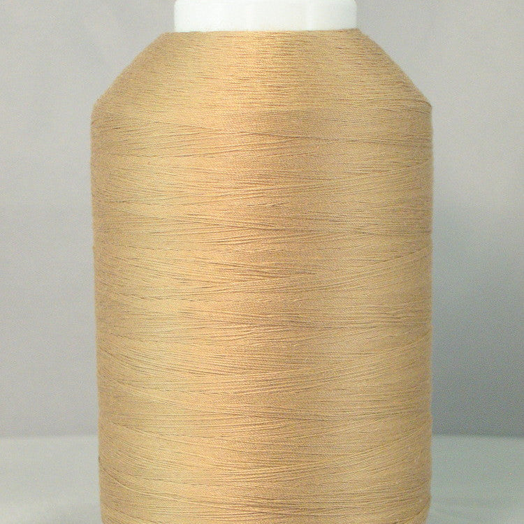 Large cone of light brown thread on white spool against gray background