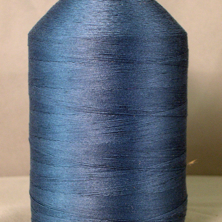 Grey blue thread on white cone spool for sewing and embroidery