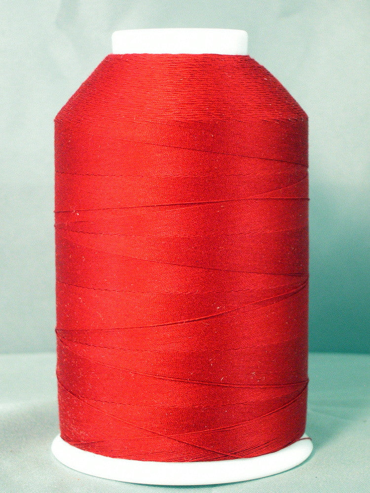Red thread cone on white spool against light blue background