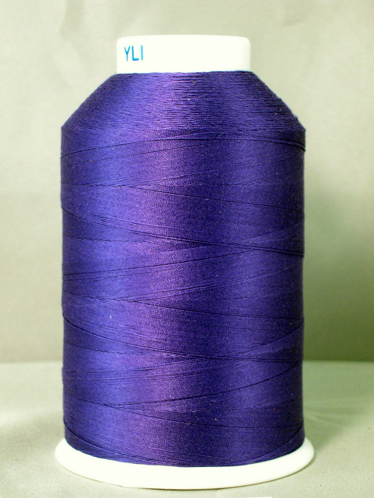 Purple thread spool on white cone with YLI label