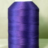 Purple thread spool on white cone with YLI label