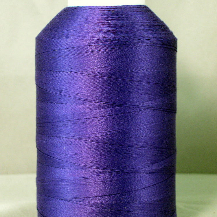 Purple thread spool on white cone with YLI label