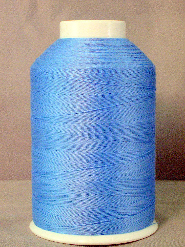 Light blue thread wound on white plastic cone spool