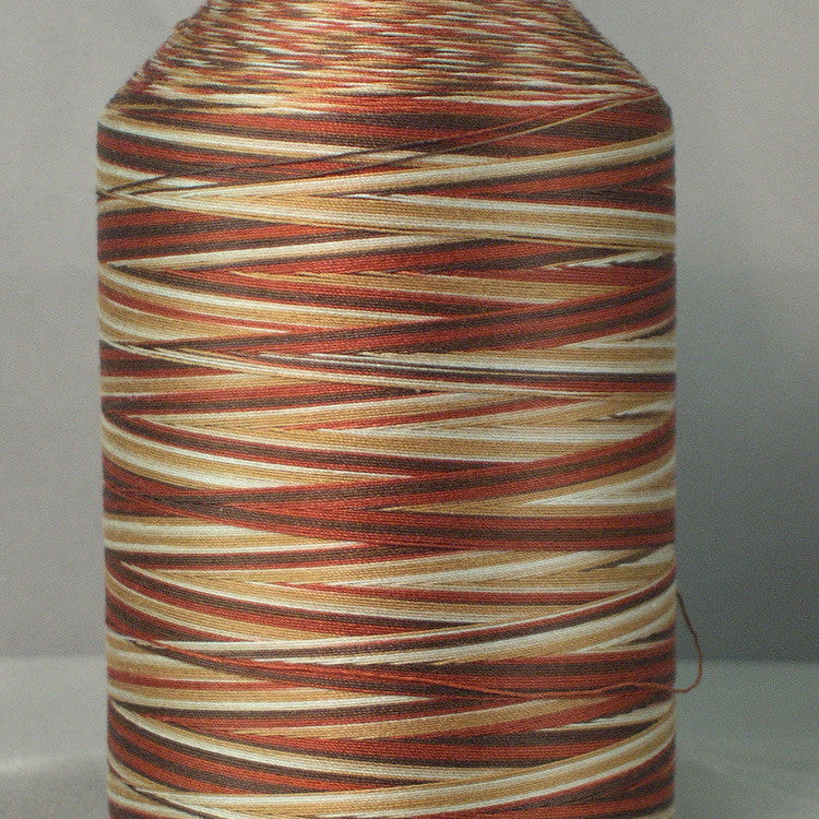 Variegated thread cone in cream to brown tones on white plastic spool