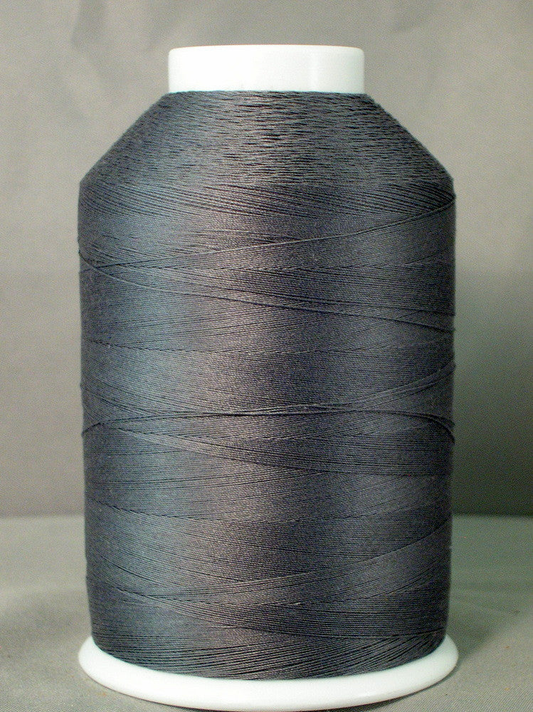 Gray thread cone on white spool for sewing and quilting