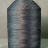 Gray thread cone on white spool for sewing and quilting