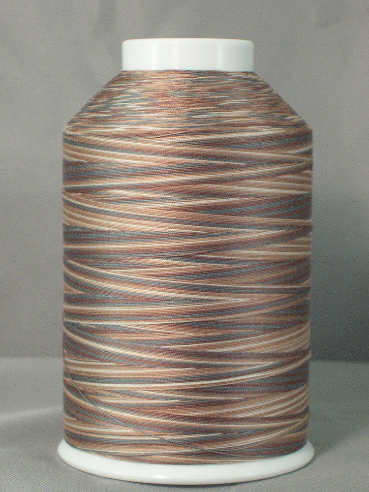Variegated brown and tan thread on white cone spool with natural wood-like color pattern
