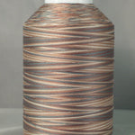 Variegated brown and tan thread on white cone spool with natural wood-like color pattern