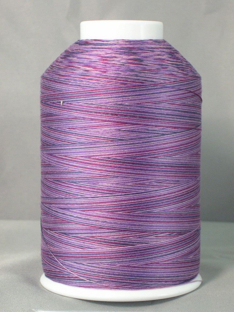 Purple variegated machine quilting thread on white cone, showing multicolored purple and pink striped pattern