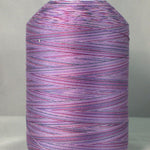Purple variegated machine quilting thread on white cone, showing multicolored purple and pink striped pattern
