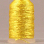 Yellow rayon thread on mini cone with cream plastic top and bottom, tightly wound with glossy finish