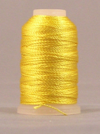 Yellow rayon thread on mini cone with cream plastic top and bottom, tightly wound with glossy finish