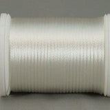 White rayon thread on white plastic spool, wound evenly with smooth lustrous finish