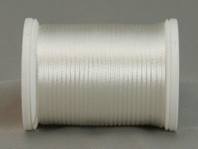 White rayon thread on white plastic spool, wound evenly with smooth lustrous finish