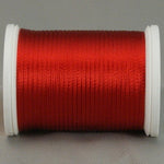 Red rayon thread on white plastic spool, smoothly wound with visible sheen