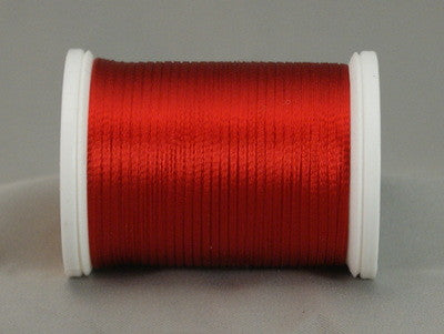 Red rayon thread on white plastic spool, smoothly wound with visible sheen