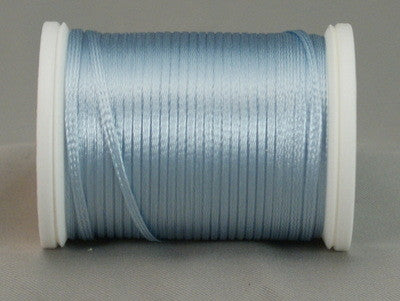 Pale blue rayon thread wound on white plastic spool with loose thread end visible