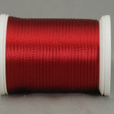 Wine red rayon thread on white plastic spool, showing smooth lustrous finish and even wind