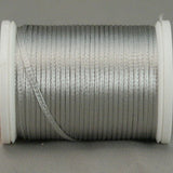 Silver rayon thread wound on white plastic spool with loose thread end visible