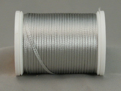 Silver rayon thread wound on white plastic spool with loose thread end visible