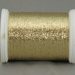 Gold metallic quilting thread on white plastic spool with shimmer finish