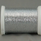 Silver metallic quilting thread wound on white plastic spool with visible shimmery texture