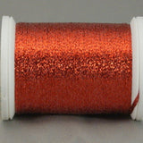 Red metallic quilting thread on white plastic spool with shimmery finish