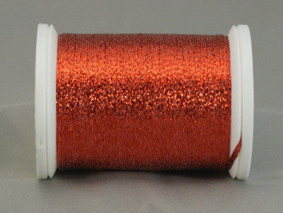 Red metallic quilting thread on white plastic spool with shimmery finish
