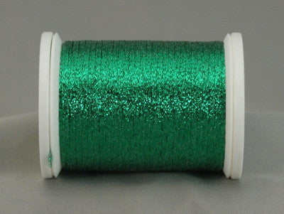 Green metallic quilting thread on white plastic spool with shimmery finish