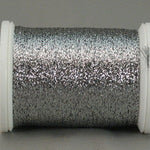 Antique silver metallic thread on white plastic spool with reflective, shimmery finish
