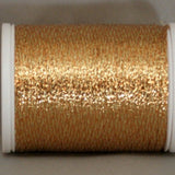 Spanish gold metallic thread on white plastic spool, shimmery textured finish